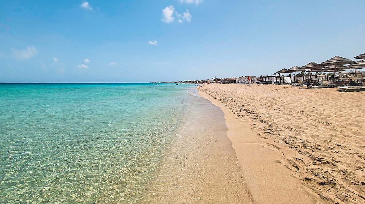 The Caribbean-turquoise shallow water and pale sand of Spiaggia di San Lorenzo near Marzamemi