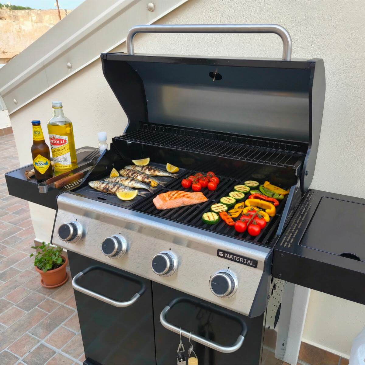 Four burner gas grill with vegatables on terrace